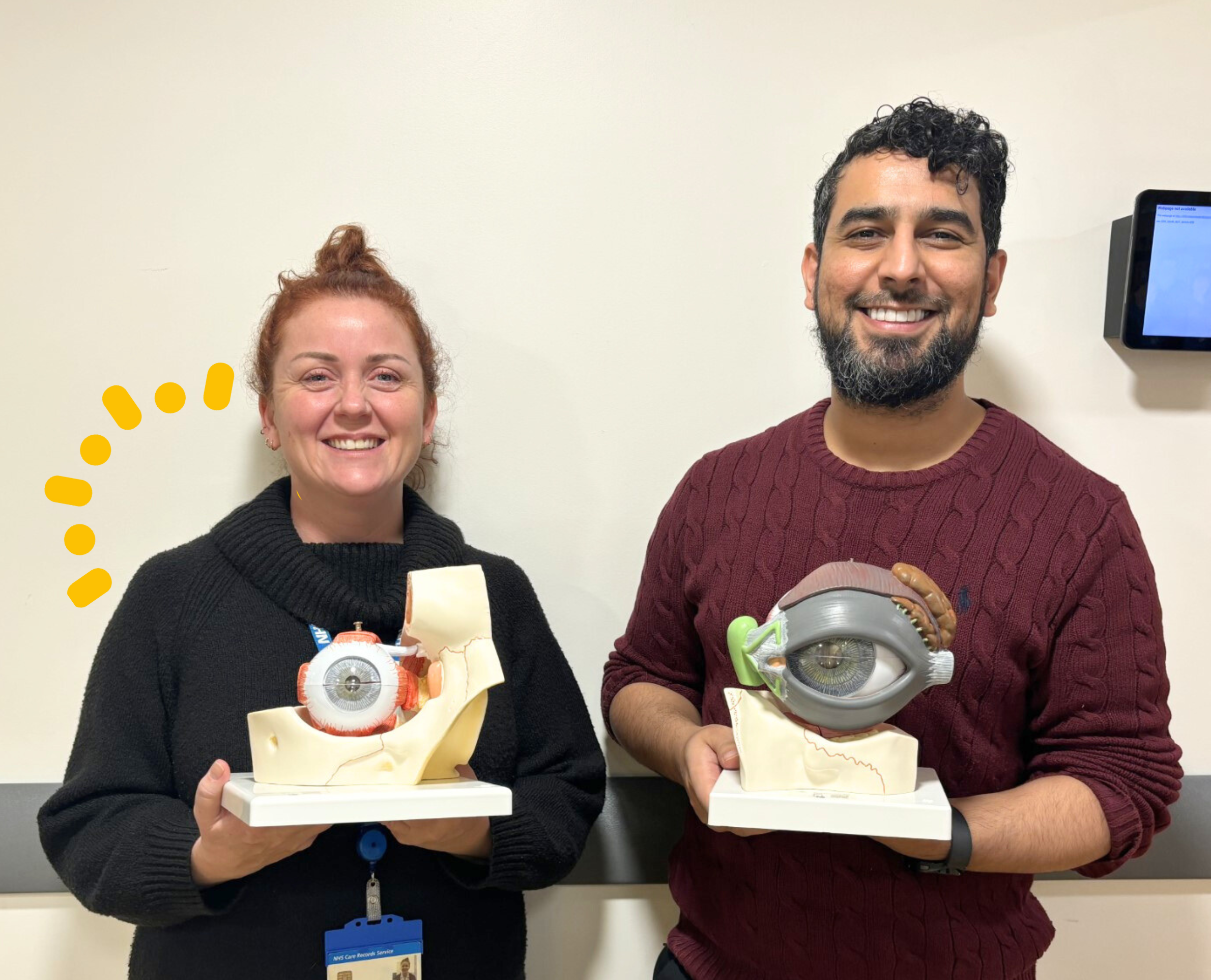 Two colleagues holding eye models that CHFT Charity funded.
